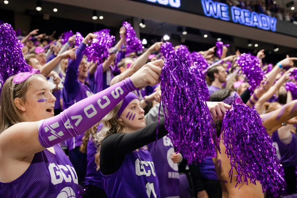 GCU Havocs pointing with purple pom poms